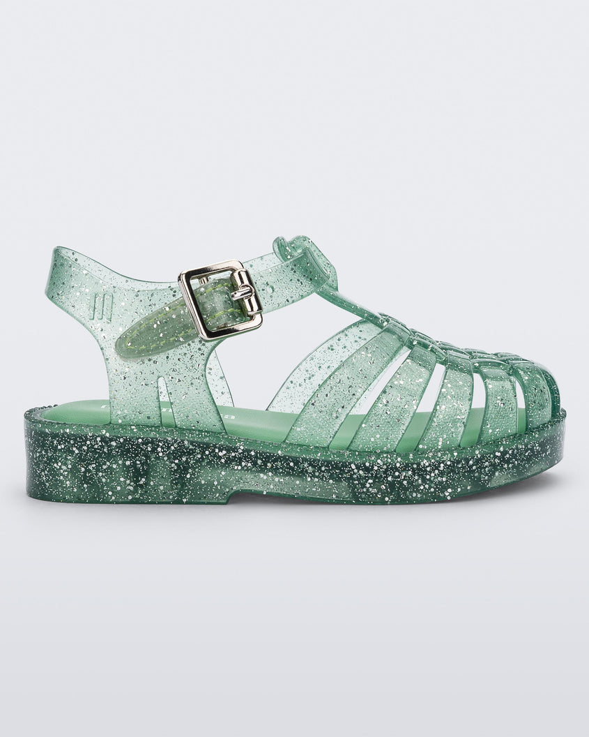 Side view of a Green/Glitter/Silver Mini Melissa Possession Shiny sandal with several straps, closed toe front and an ankle strap.