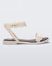 Side view of a beige/brown Melissa Wave Blossom Sandal with a floral detail front and ankle strap.