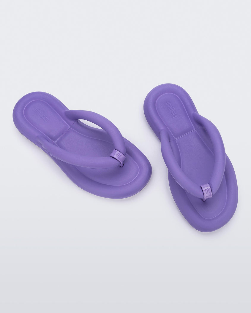 Top view of a pair of lilac Melissa Free Flip Flops with puffer-like straps.