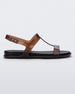 Side view of a clear brown / black Melissa Adore sandal with two translucent brown straps, joined together by a third strap and a black insole.