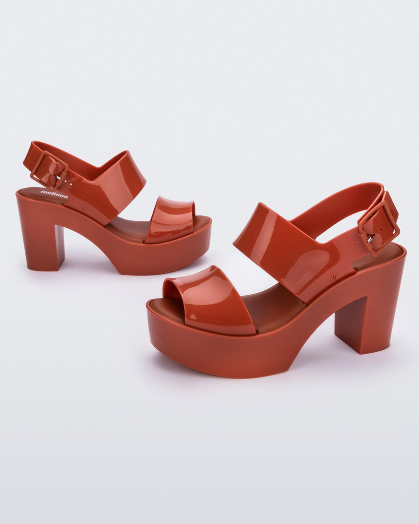 Angled view of a pair of red Melissa Mule Sandals with platform heel.