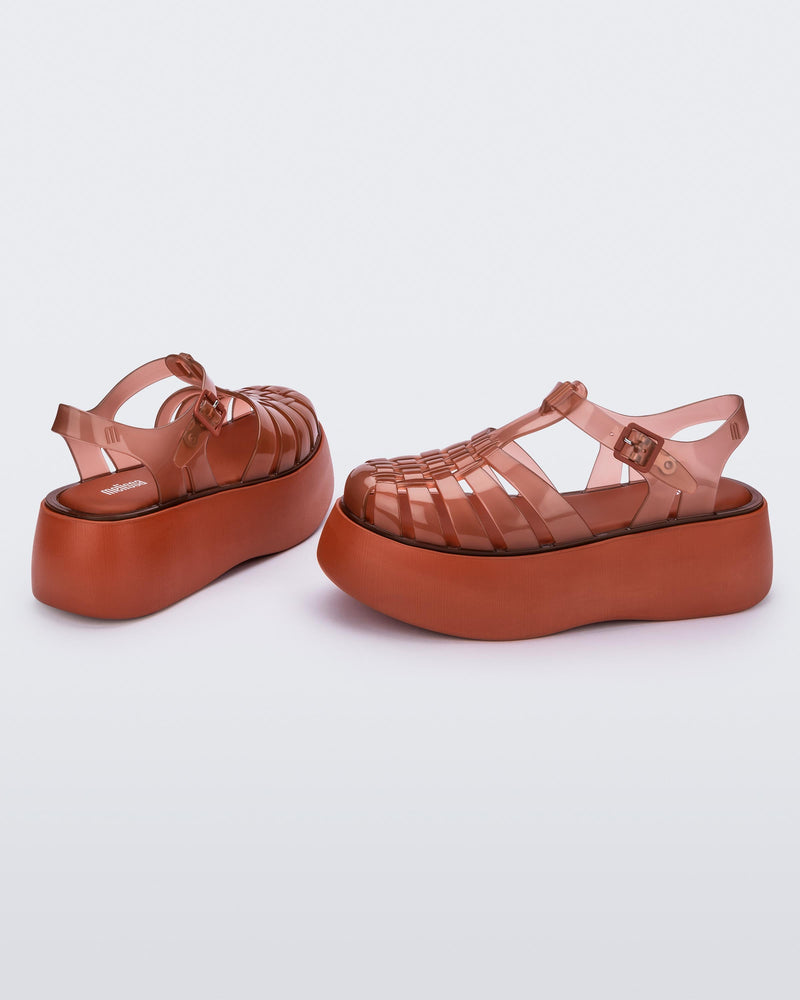A side and back view of a pair of brown Melissa Possession Platform sandals with several straps and a closed toe front.