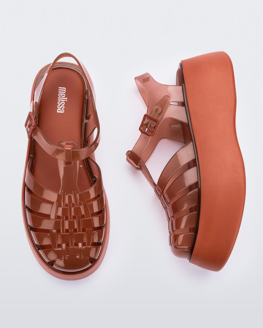 A top and side view of a pair of brown Melissa Possession Platform sandals with several straps and a closed toe front.