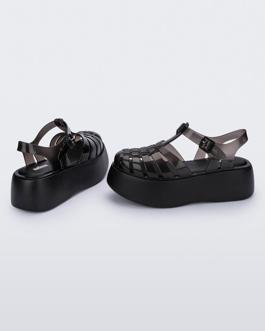 A side and back view of a pair of black Melissa Possession Platform sandals with several straps and a closed toe front.