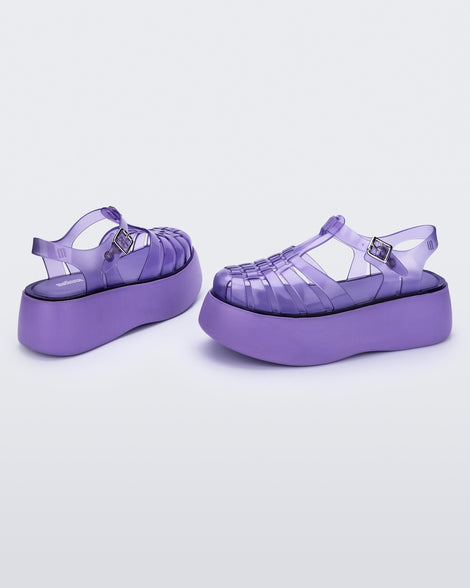 An angled side and back view of a pair of a lilac Melissa Possession Platform sandals with several straps and a closed toe front.