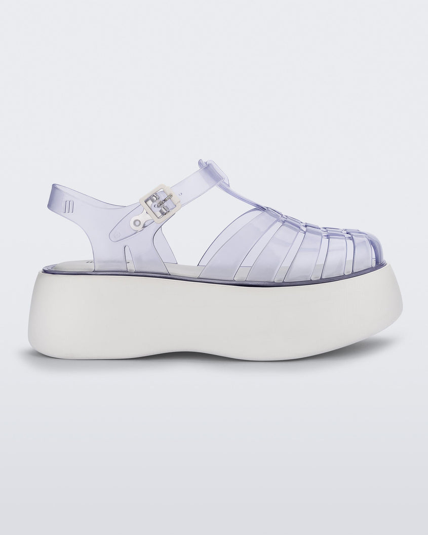 Side view of a Clear/White Melissa Possession Platform sandal with several straps and a closed toe front.