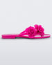 Side view of a pink Melissa Harmomic Squared Garden flip flop with flowers on the straps.