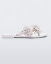 Side view of a white Melissa Harmonic Garden flip flop with flowers on the straps.