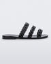 Side view of a black Melissa Feel slide with three chain detail straps.
