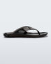Side view of a clear black Melissa Real Jelly Flip Flop.