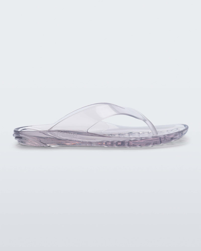 Side view of a clear Melissa Real Jelly Flip Flop.