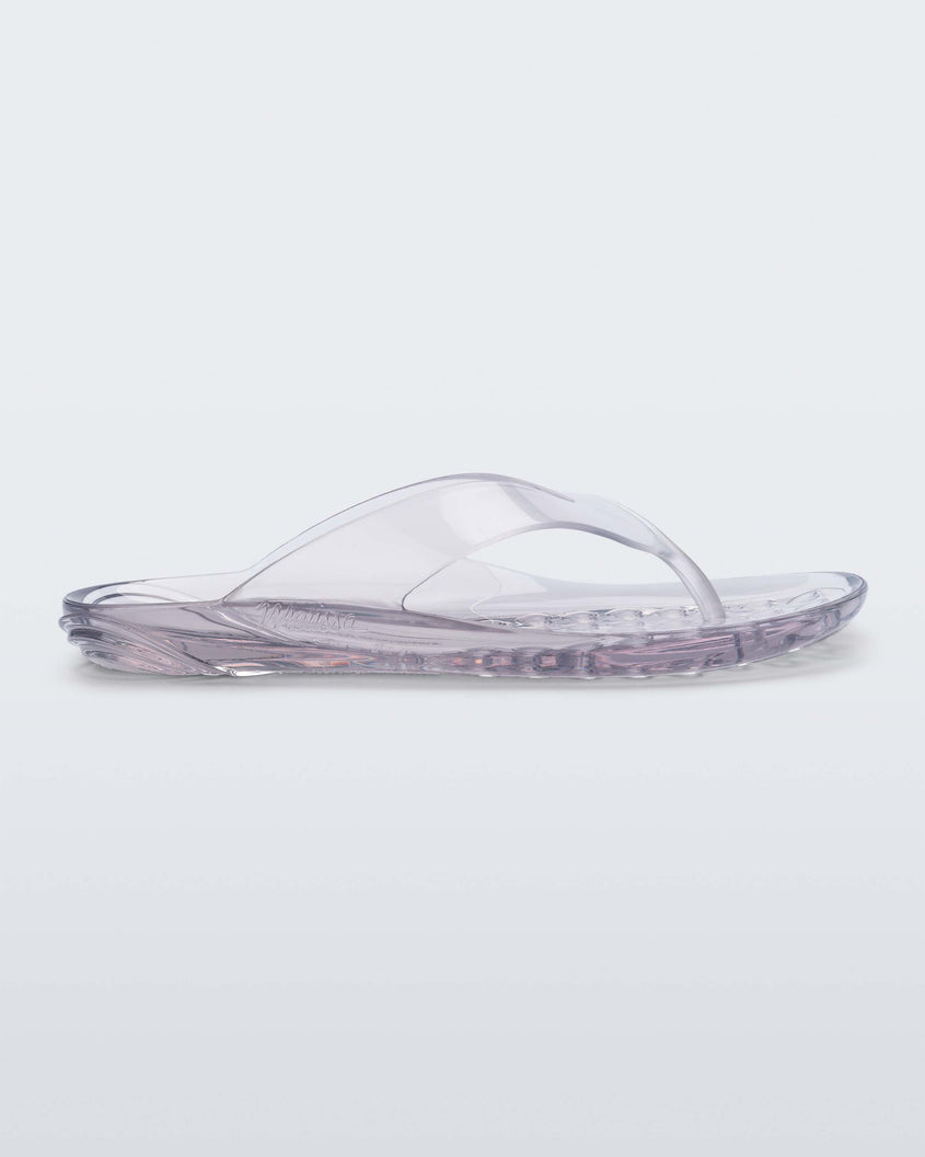 Side view of a clear Melissa Real Jelly Flip Flop.