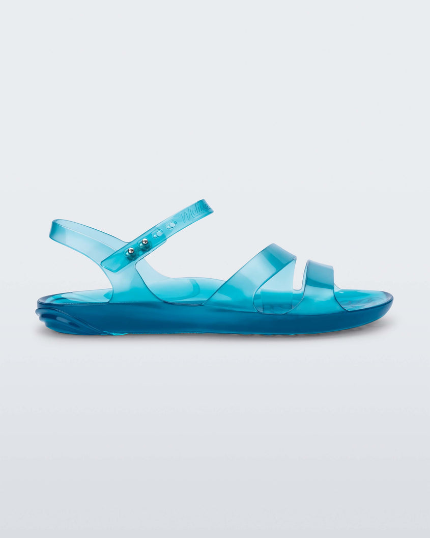 Side view of a blue Melissa Real Jelly Sandal with two front straps and an ankle strap.