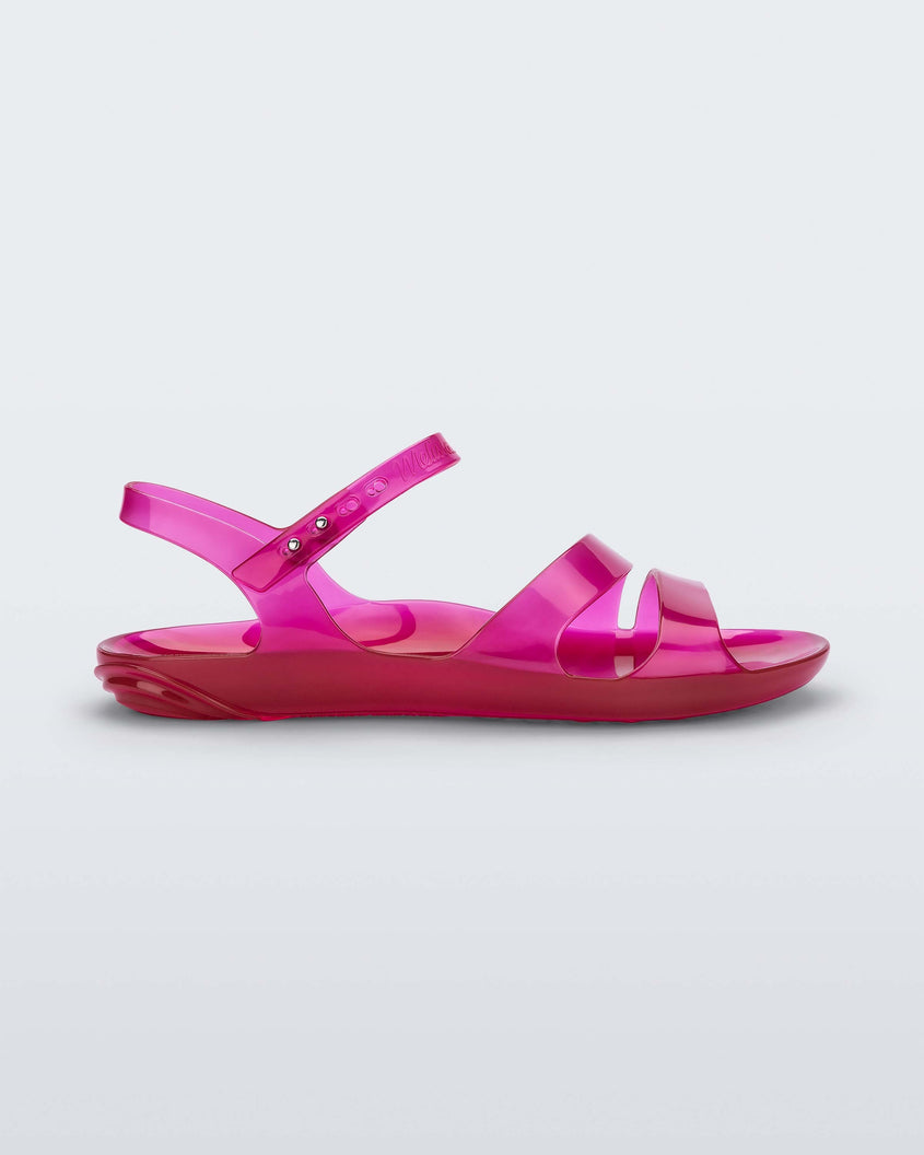 Side view of a pink Melissa Real Jelly Sandal sandal with two front straps and an ankle strap.