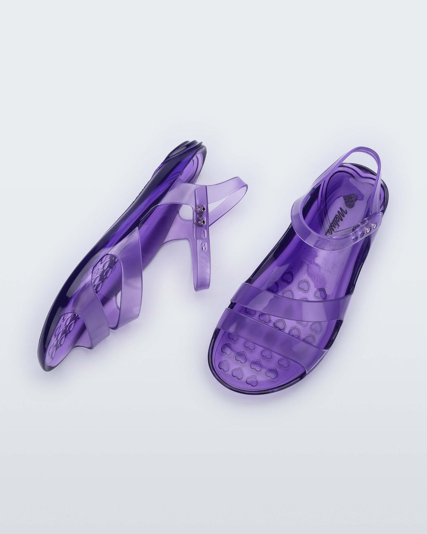 A top and side view of a pair of lilac Melissa Real Jelly Sandals with two front straps and an ankle strap.