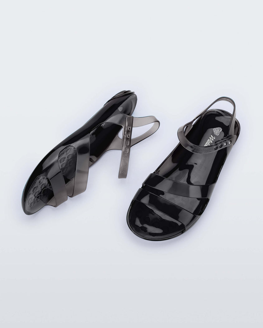 A top and side view of a pair of black Melissa Real Jelly Sandals with two front straps and an ankle strap.