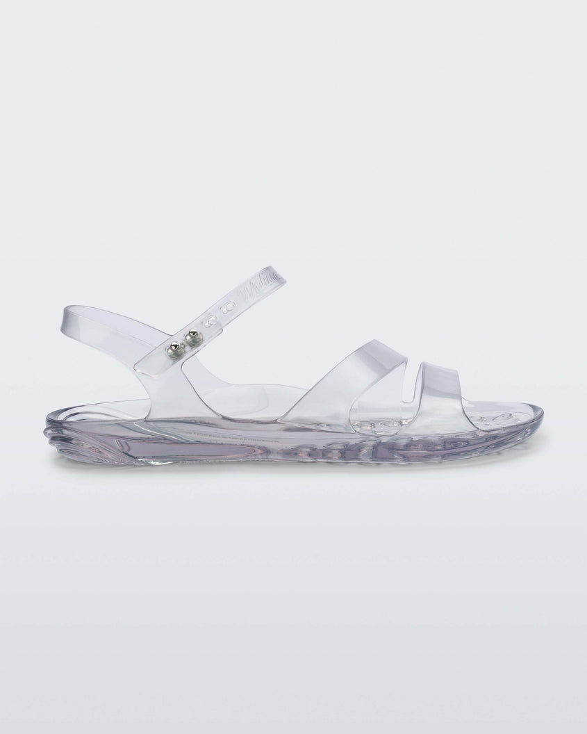 Side view of a clear Melissa Real Jelly Sandal with two front straps and an ankle strap.
