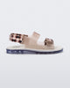 An inner side view of a clear brown Melissa Brave Papete sandals with a white insole, brown circle print, transparent beige straps and a velcro back.