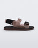 Side view of a brown Melissa Brave Papete sandal with two straps, a brown base, black sole, and a front and back black velcro strap.