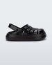 Side view of a black Mini Melissa Sunday sandal with woven closed toe front and back ankle strap.