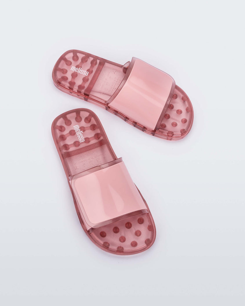 Top view of a pair of pink Melissa Brave Slides with a pink velcro top strap and translucent pink insole.