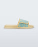 Side view of a pair of yellow/blue Melissa Brave Slide with a yellow and blue floral patterned velcro top strap and yellow insole.