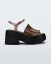 Side view of a black/brown Melissa Pose platform sandal with a brown front strap, a clear brown ankle strap and a black sole.