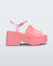 Side view of a pink Melissa Pose platform sandal with a pink front strap, a clear pink ankle strap and a pink sole.