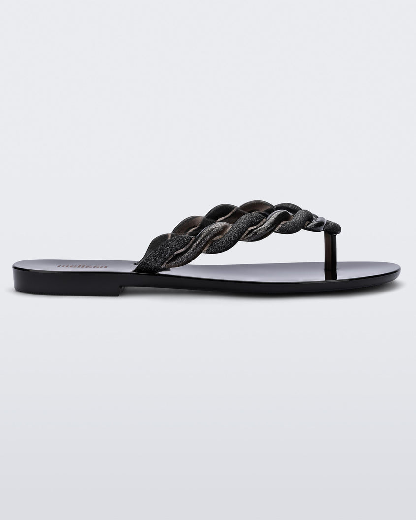 Side view of a Black/Gold Melissa Louise Flip Flop with glitter twisted rope like straps.
