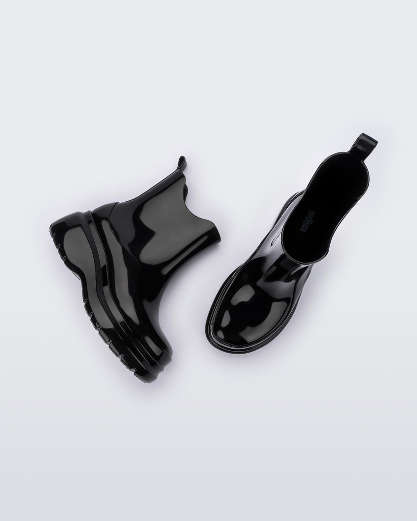 A top and side view of a pair of black Melissa Grip short rain boots.