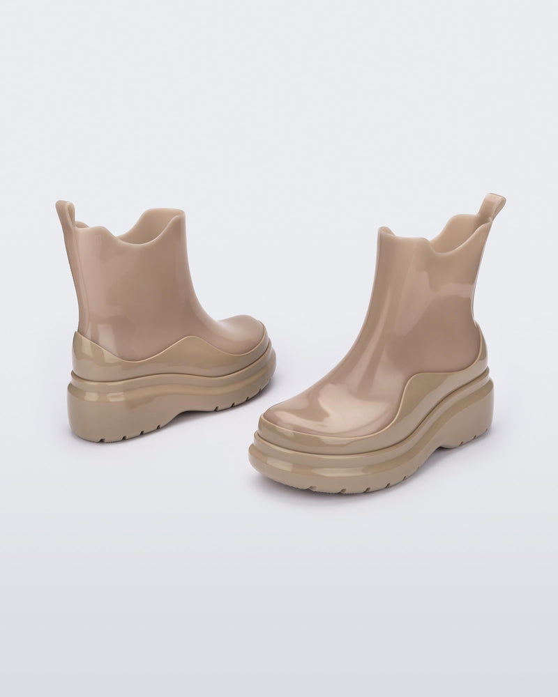 An angled side view of a pair of brown Melissa Grip short rain boots.