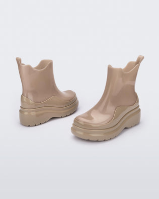 An angled side view of a pair of brown Melissa Grip short rain boots.