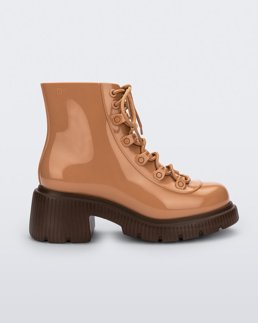 Side view of a bronze/beige Melissa Cosmo boots with a bronze/beige base, laces and a brown heel sole.