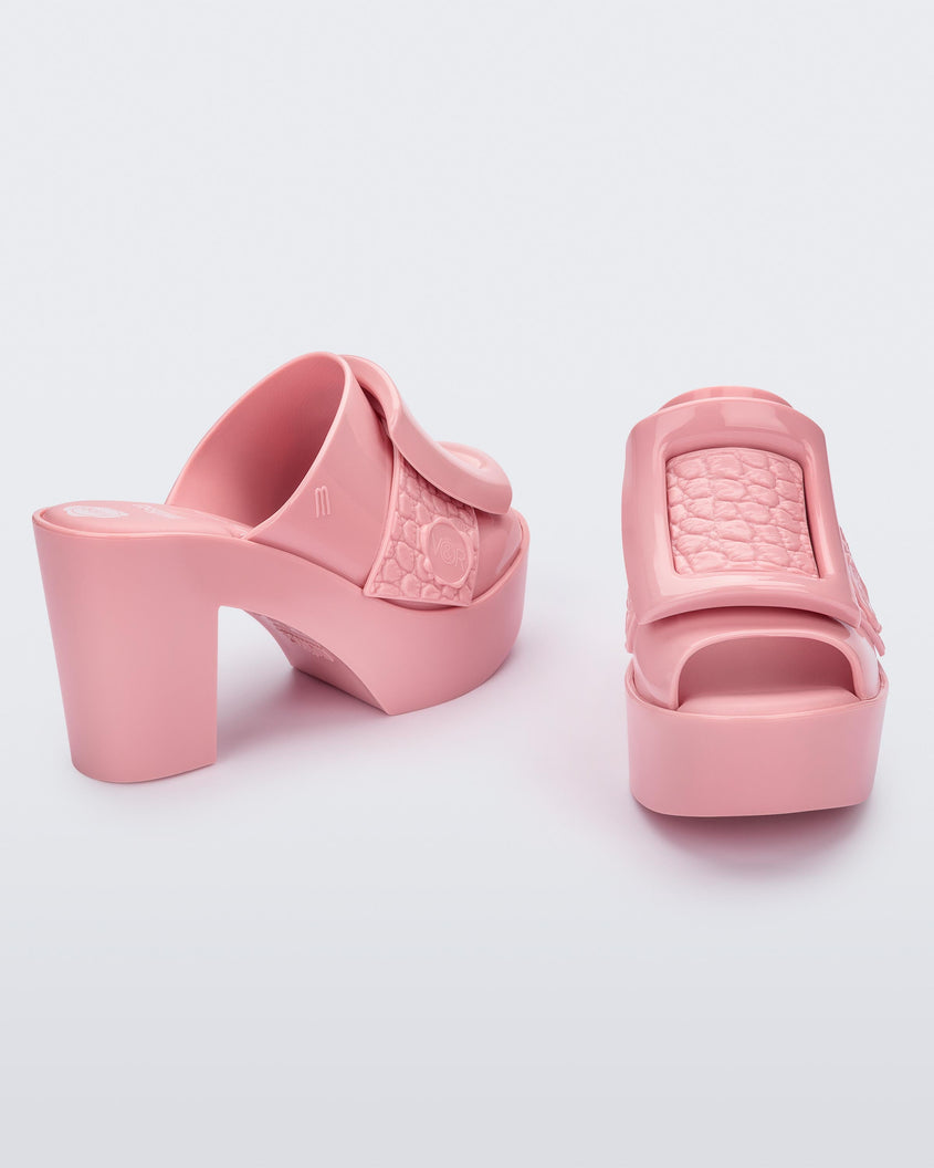 Angled view of a pair of pink Meilssa Buckle Up platform heeled mules.