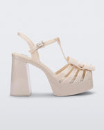 Side view of a Melissa Tie Party platform heel sandal in Beige with ankle strap and buckle closure and 3D bow detail on front straps