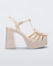 Side view of a Melissa Tie Party platform heel sandal in Beige with ankle strap and buckle closure and 3D bow detail on front straps