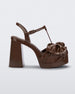 Side view of a Melissa Tie Party platform heel in brown with 3D bow detail and ankle strap with buckle. 