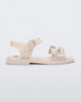Side view of a Beige/Beige Melissa Tie Mar Sandal with a beige base, an ankle strap and a front strap with a beige bow on the front.