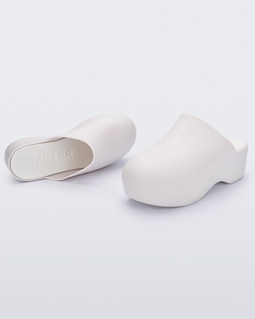 A front and top view of a pair of macadamia Melissa Bubble Matte mules.