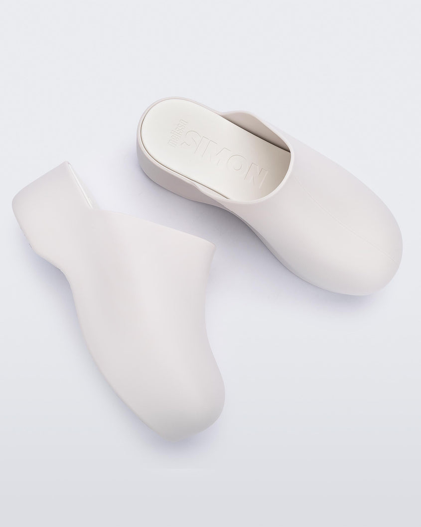 A side and top view of a pair of macadamia Melissa Bubble Matte mules.