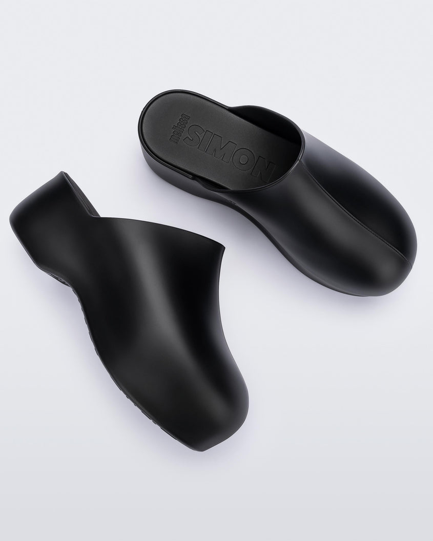 Top and side view of a pair of black Melissa Bubble clogs from the Simon Miller collaboration.