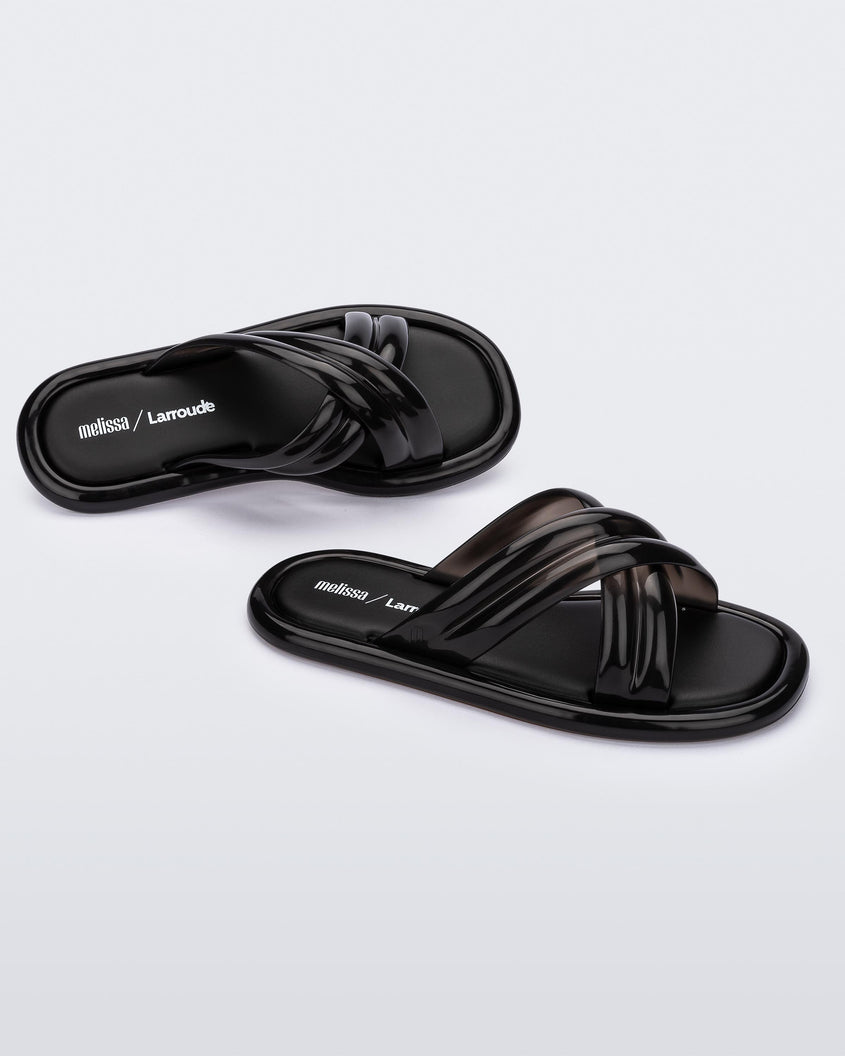 Top and side view of a pair of black Melissa Cali slides with cross straps.