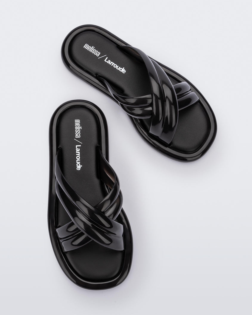 Top view of a pair of black Melissa Cali slides with cross straps.