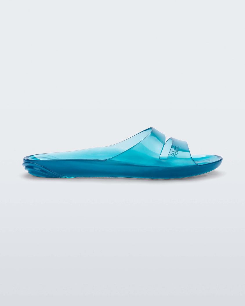 Side view of a clear blue Melissa Real Jelly Slide with two front straps.