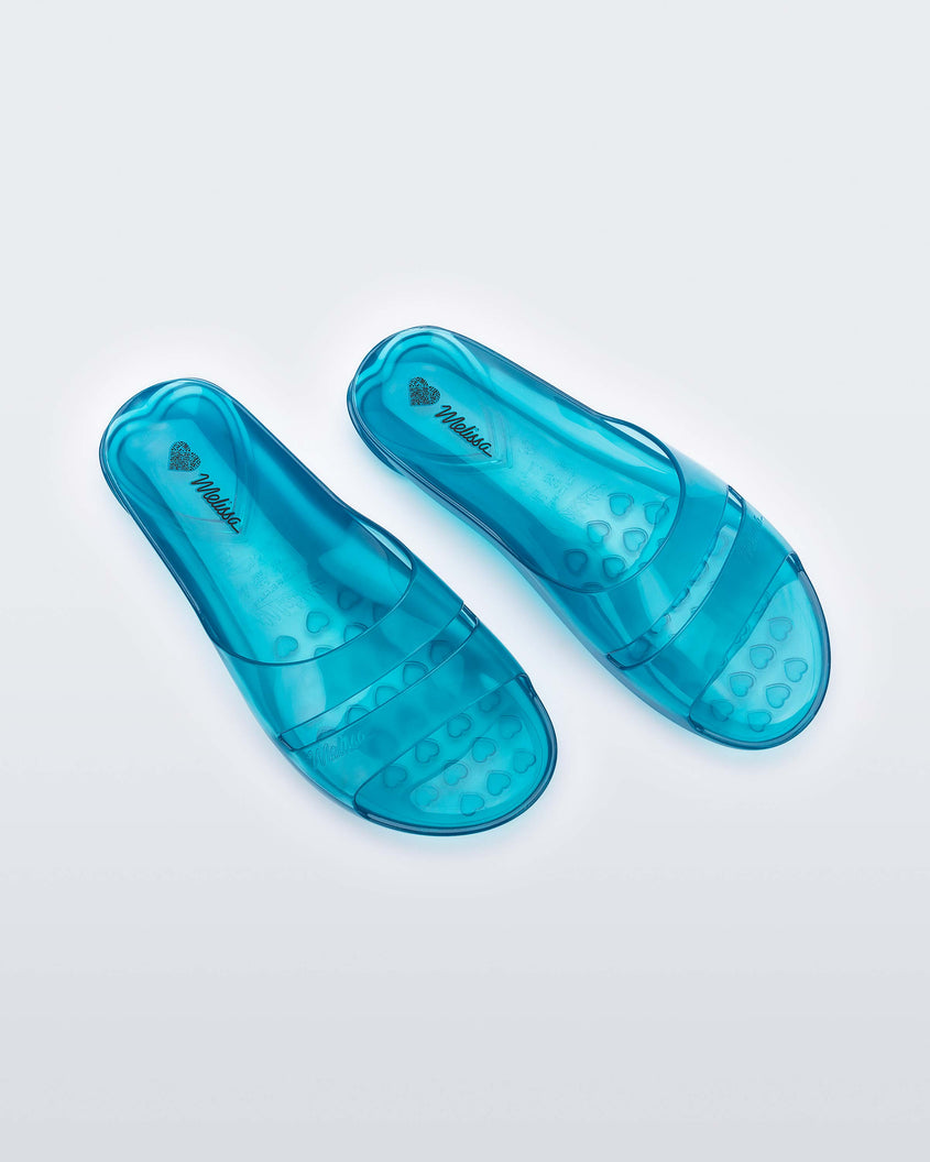 Top view of a pair of a clear blue Melissa Real Jelly Slides with two front straps.