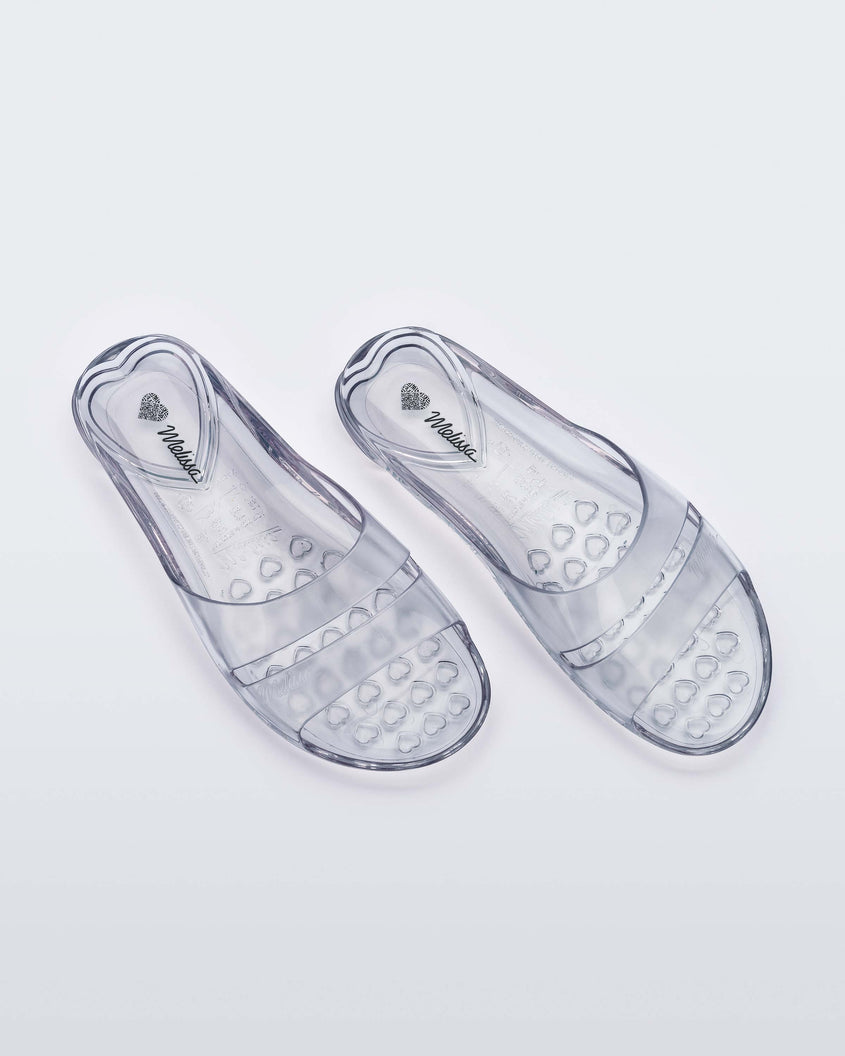 Top view of a pair of clear Melissa Real Jelly Slides with two front straps.