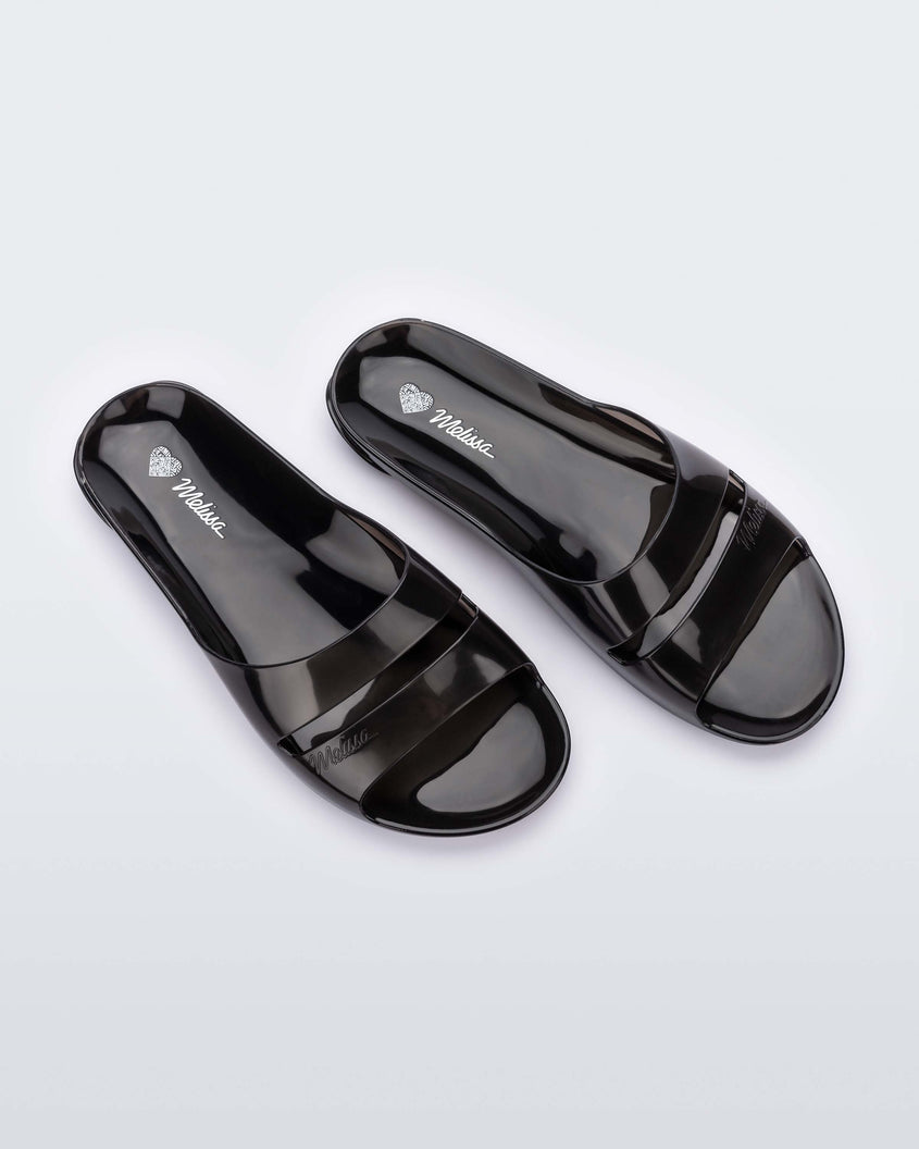 Top view of a pair of Transparent Black Melissa Real Jelly Slides with two front straps.
