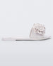 Side view of a white Melissa Babe Garden slide with two flowers on the front strap.