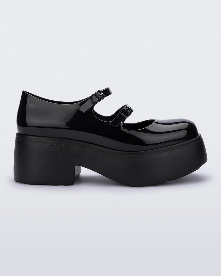 Side view of a black Melissa Farah platform with two top straps.