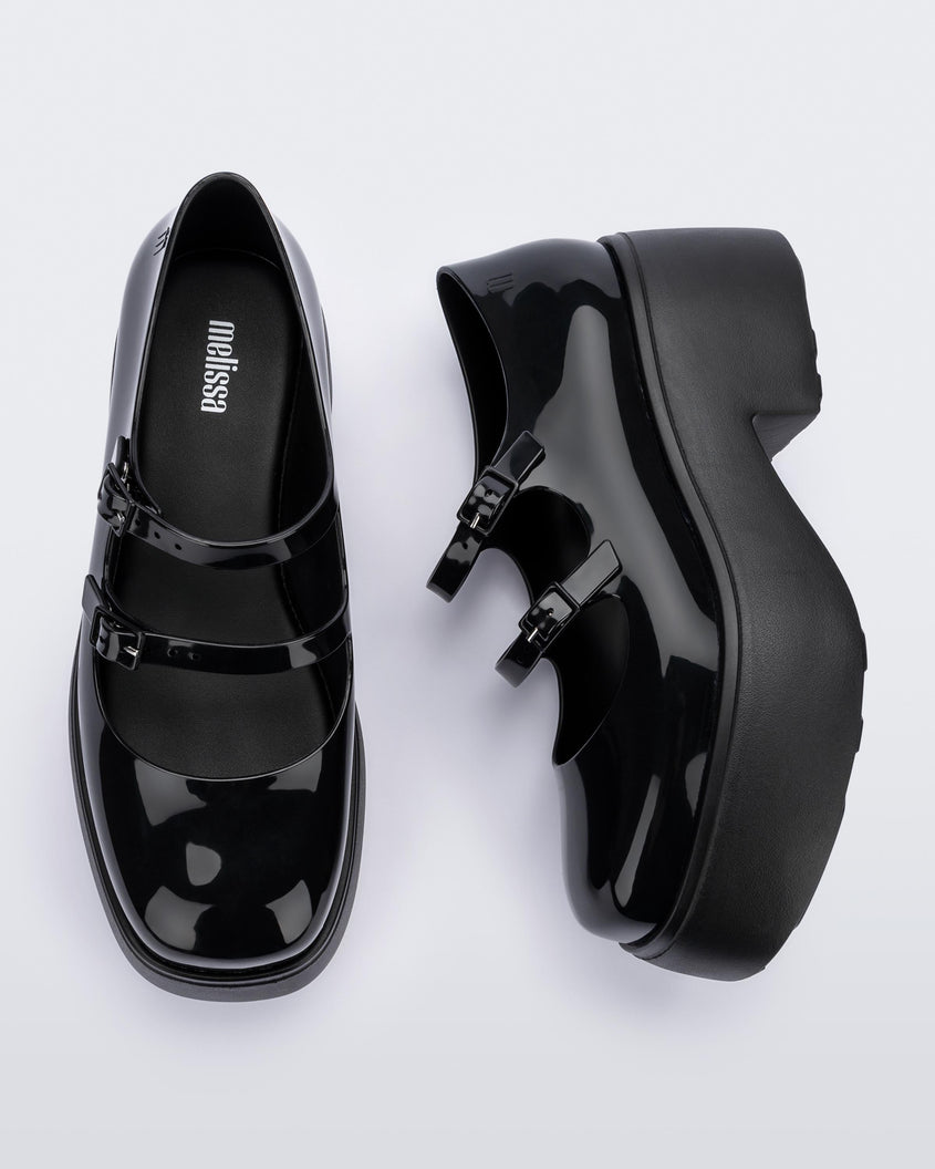 A top and side view of a pair of black Melissa Farah platforms with two top straps.